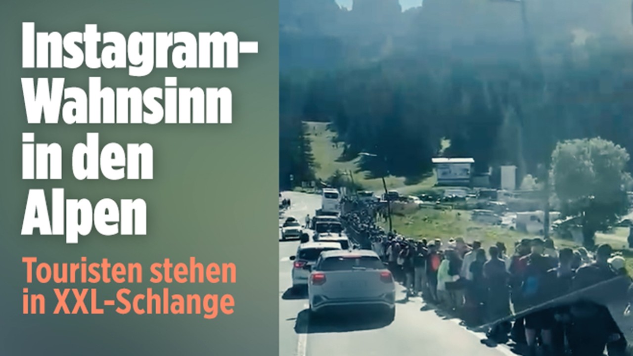 Drei Zinnen Tourismus – Urlauber stehen Schlange auf einen Shuttlebus für die Drei-Zinnen-Wanderung in den Dolomiten