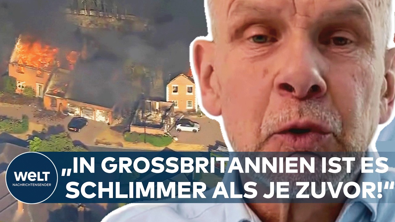 Feuerwehrleute bekämpfen einen Waldbrand in Großbritannien, Flammen schlagen auf Wohngebäude über