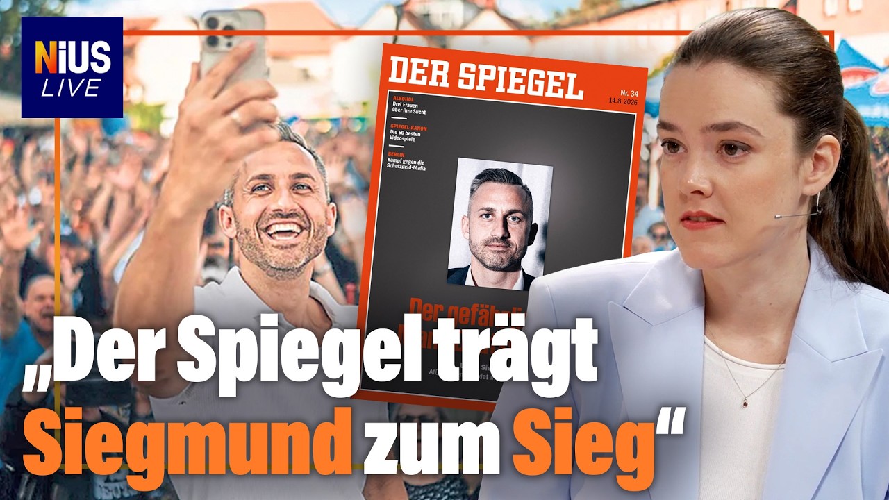 Spiegel-Cover Sigmund – Ulrich Sigmund signiert lächelnd das Spiegel-Cover, das ihn als gefährlichsten Mann Deutschlands bez…