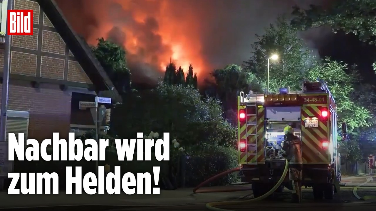 Feuerwehrmann rettet Bewohner aus brennendem Einfamilienhaus bei Nacht mit meterhohen Flammen