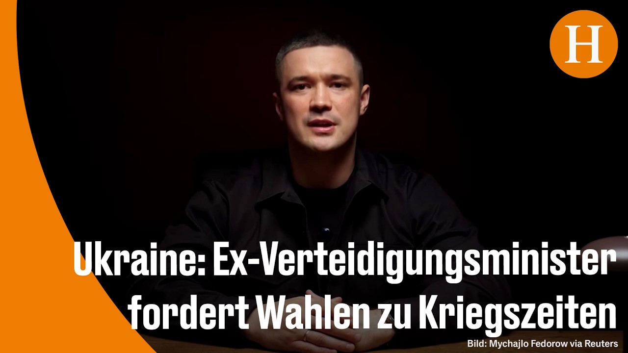 Ukrainischer Ex-Verteidigungsminister Ferderov spricht vor Mikrofonen über Demokratie und Wahlen in der Ukraine