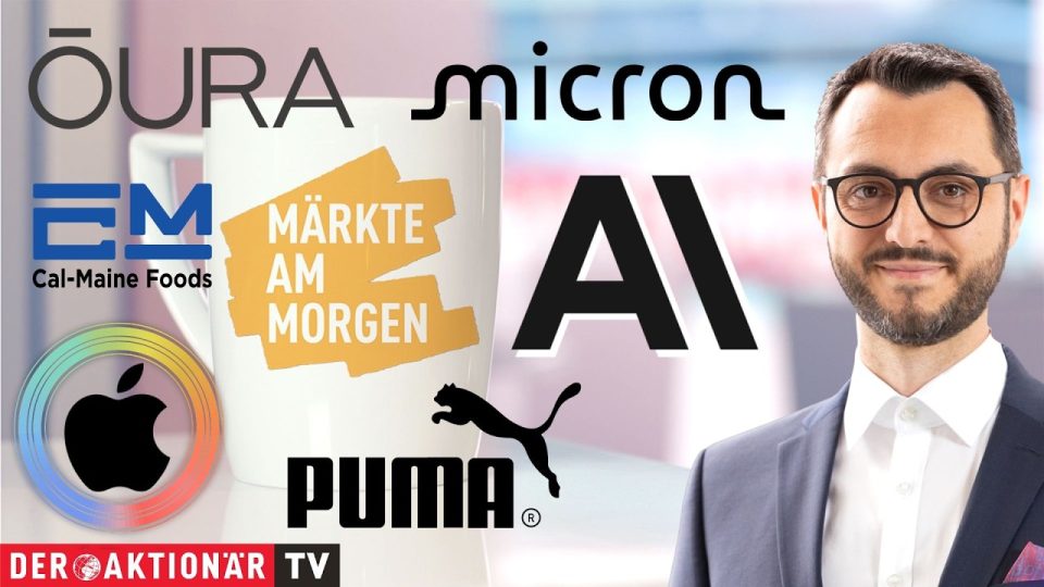 Händler an der Börse verfolgen die Märkte am Morgen auf digitalen Kursanzeigen mit Apple- und Micron-Aktien