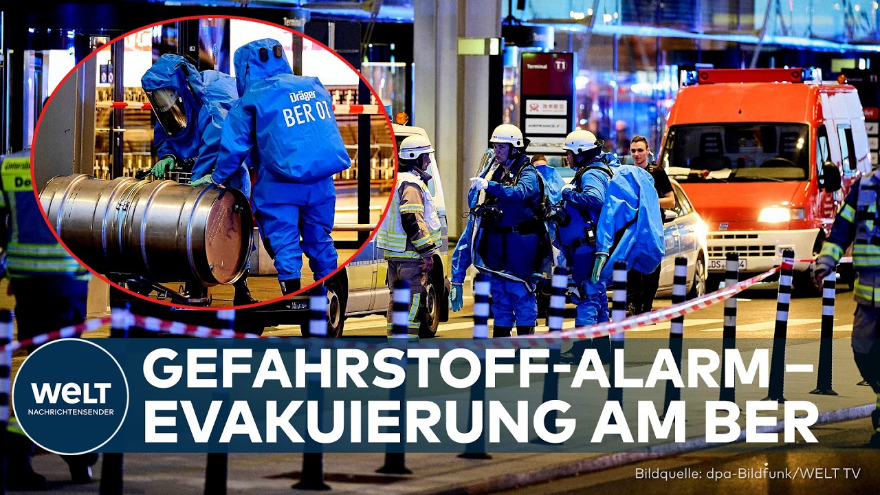 Gefahrstoff-Alarm BER – Spezialkräfte in Schutzanzügen vor dem Terminal des Berliner Flughafens BER beim Gefahrstoff-Alarm