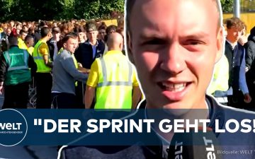 Besucher sprinten beim Oktoberfest 2026 über die Theresienwiese in München zum Festzelt