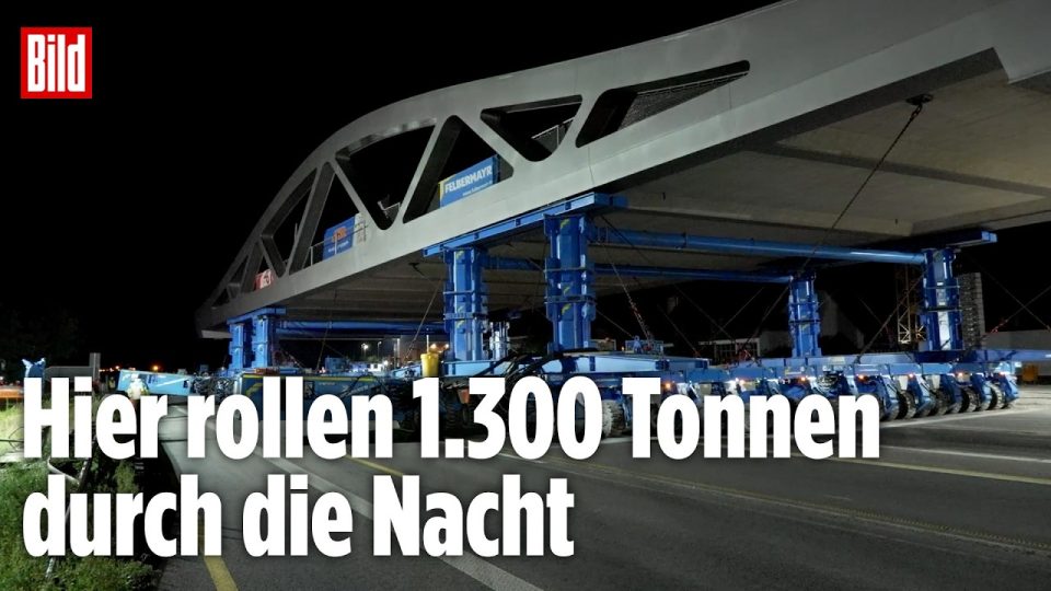 Computergesteuerter Schwerlasttransporter bringt eine 1.300 Tonnen schwere Stahlverbundbrücke beim Brückentransport A70 in P…