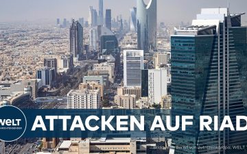 Rauchsäule über einer Stadt nach einem Huthi-Angriff auf Riad, Saudi-Arabien, mit Abwehrraketen am Himmel