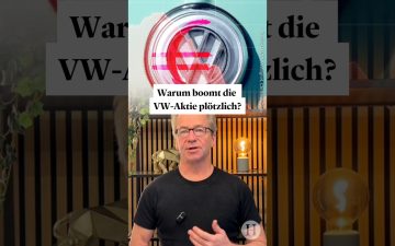 VW-Aktie Kursanstieg im DAX – Volkswagen-Logo vor Börsentafel mit steigenden Kursen