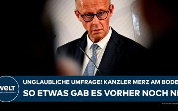 Merz Umfrage – Bundeskanzler Friedrich Merz am Rednerpult – Merz-Umfrage zeigt historischen Tiefstwert bei Zufriedenheit