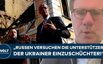 Bundeskanzler Merz bei seinem Besuch in Kiew, im Hintergrund ukrainische Flaggen – Merz Kiew Besuch