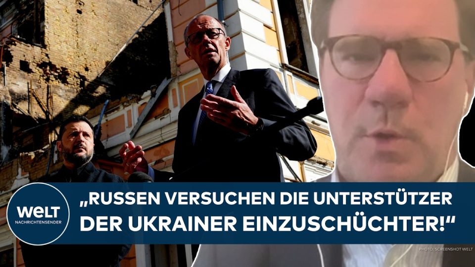 Bundeskanzler Merz bei seinem Besuch in Kiew, im Hintergrund ukrainische Flaggen – Merz Kiew Besuch