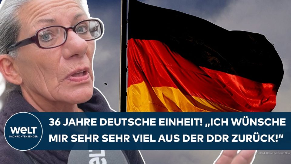 Deutsche Einheit – Menschen auf einer Straße in Berlin am Tag der Deutschen Einheit – Symbol für Ost-West-Spaltung und Wiede…